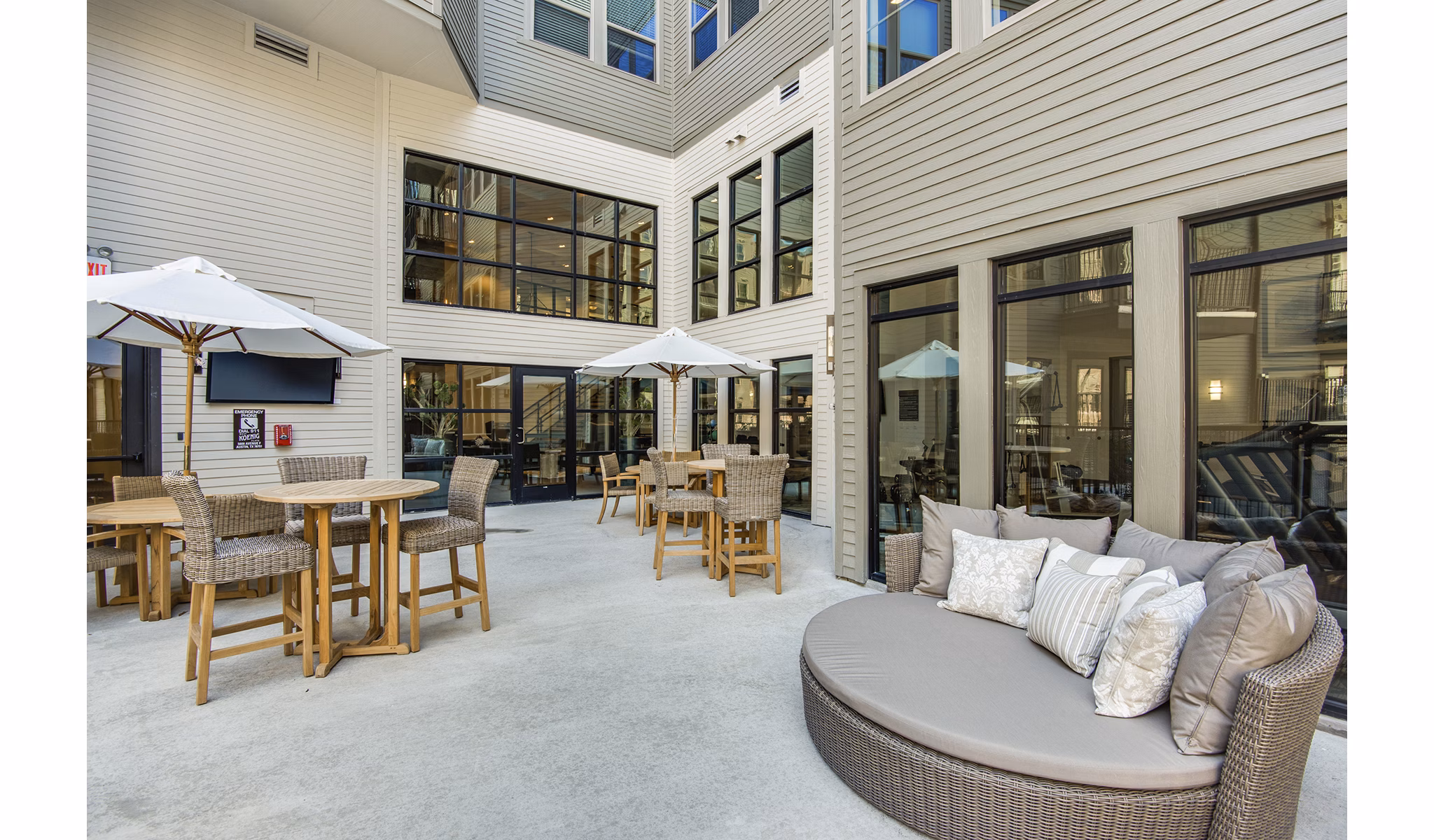 Outdoor lounging area with modern seating and greenery at West Koenig Flats Apartments