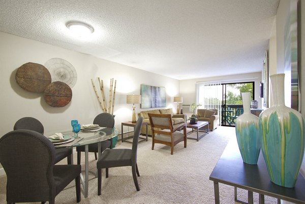 Summit Ridge Apartments: Open-concept living and dining area with contemporary decor featuring stylish furniture and modern lighting