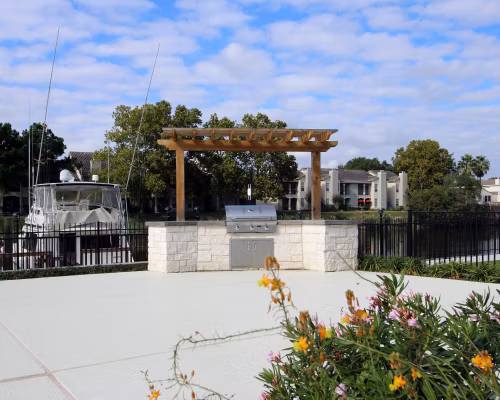 Outdoor grill area with modern seating at CP Waterfront Apartments, perfect for social gatherings and entertaining guests