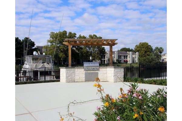 Outdoor grill area with modern seating at CP Waterfront Apartments, perfect for social gatherings and entertaining guests