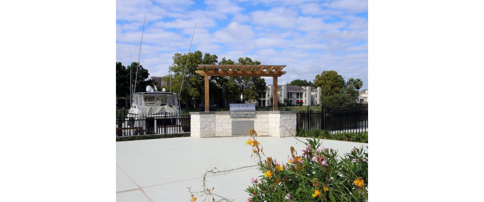 Outdoor grill area with modern seating at CP Waterfront Apartments, perfect for social gatherings and entertaining guests