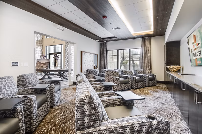 Modern theater room with plush seating at Overture Stone Oak luxury apartments