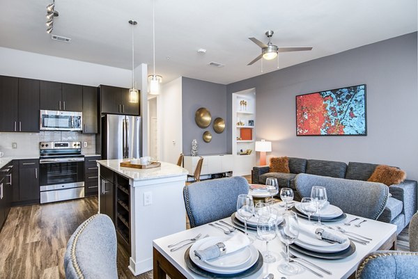 Dining room with elegant decor and modern lighting at Overture Stone Oak luxury apartments