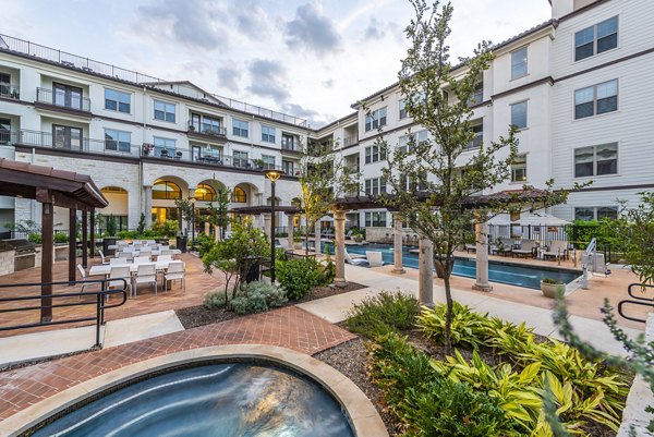 Luxurious pool with sundeck at Overture Stone Oak, perfect for relaxation and gatherings at this upscale property