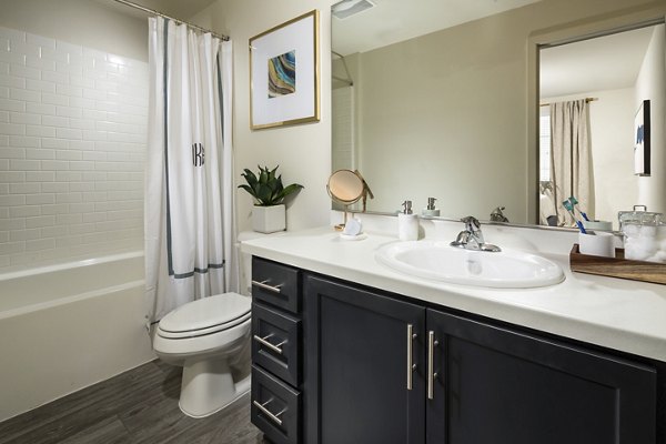 Solaire Apartments: Modern bathroom featuring sleek fixtures and marble accents in luxury setting