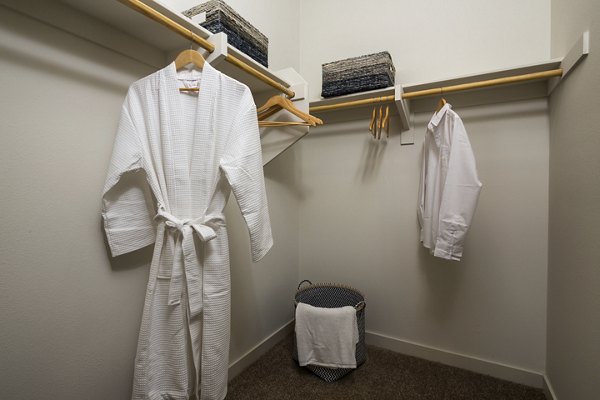 Walk-in closet with built-in shelves at Solaire Apartments, providing ample storage for luxury living