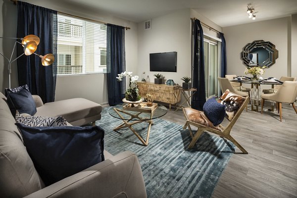 Spacious living room with modern decor and large windows in Solaire Apartments, by Greystar