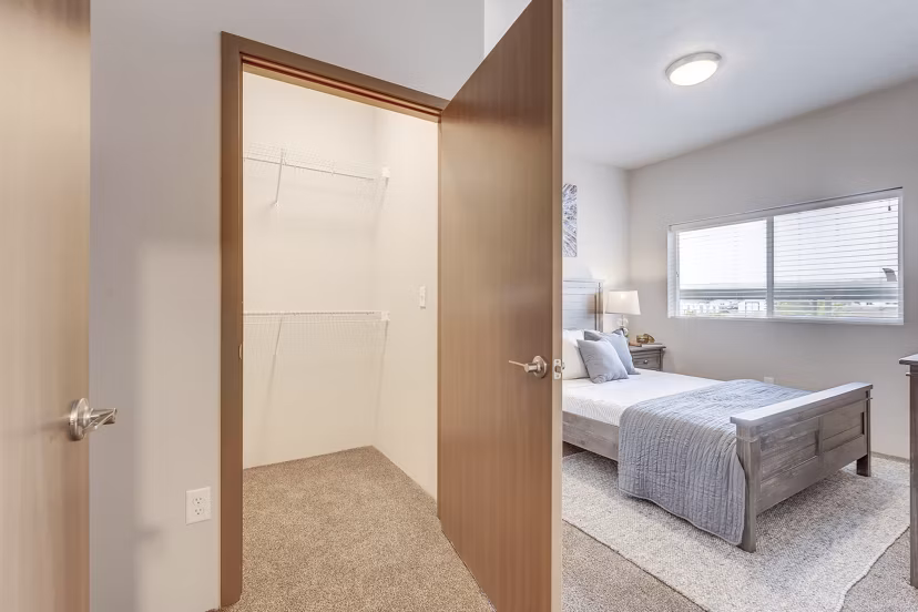 Walk-in closet with ample shelving at Bella Tess Apartments, perfect for organized storage in luxury living spaces