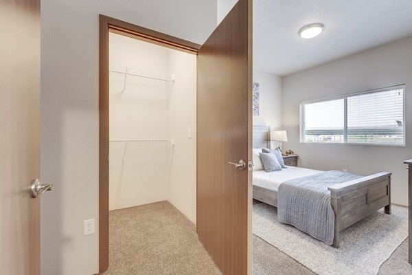 Walk-in closet with ample shelving at Bella Tess Apartments, perfect for organized storage in luxury living spaces