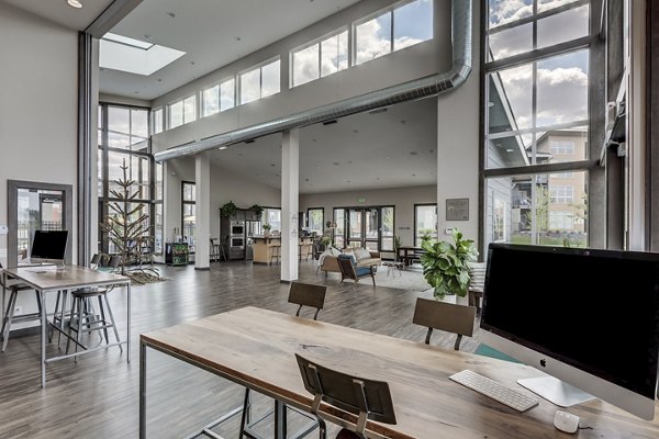 Modern clubhouse with elegant seating and game areas at Bella Tess Apartments, ideal for social gatherings and relaxation