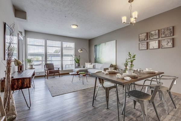 Dining area with modern furnishings at Bella Tess Apartments: Luxurious gathering space in sought-after community