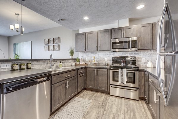 Modern kitchen with stainless steel appliances at Bella Tess Apartments
