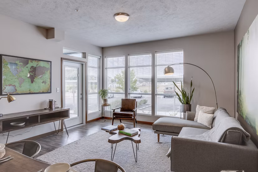 Stylish living room with modern furnishings at Bella Tess Apartments, featuring a comfortable seating area and contemporary design