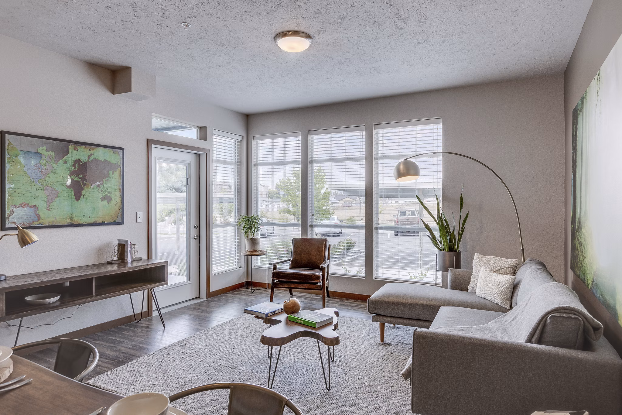 Stylish living room with modern furnishings at Bella Tess Apartments, featuring a comfortable seating area and contemporary design