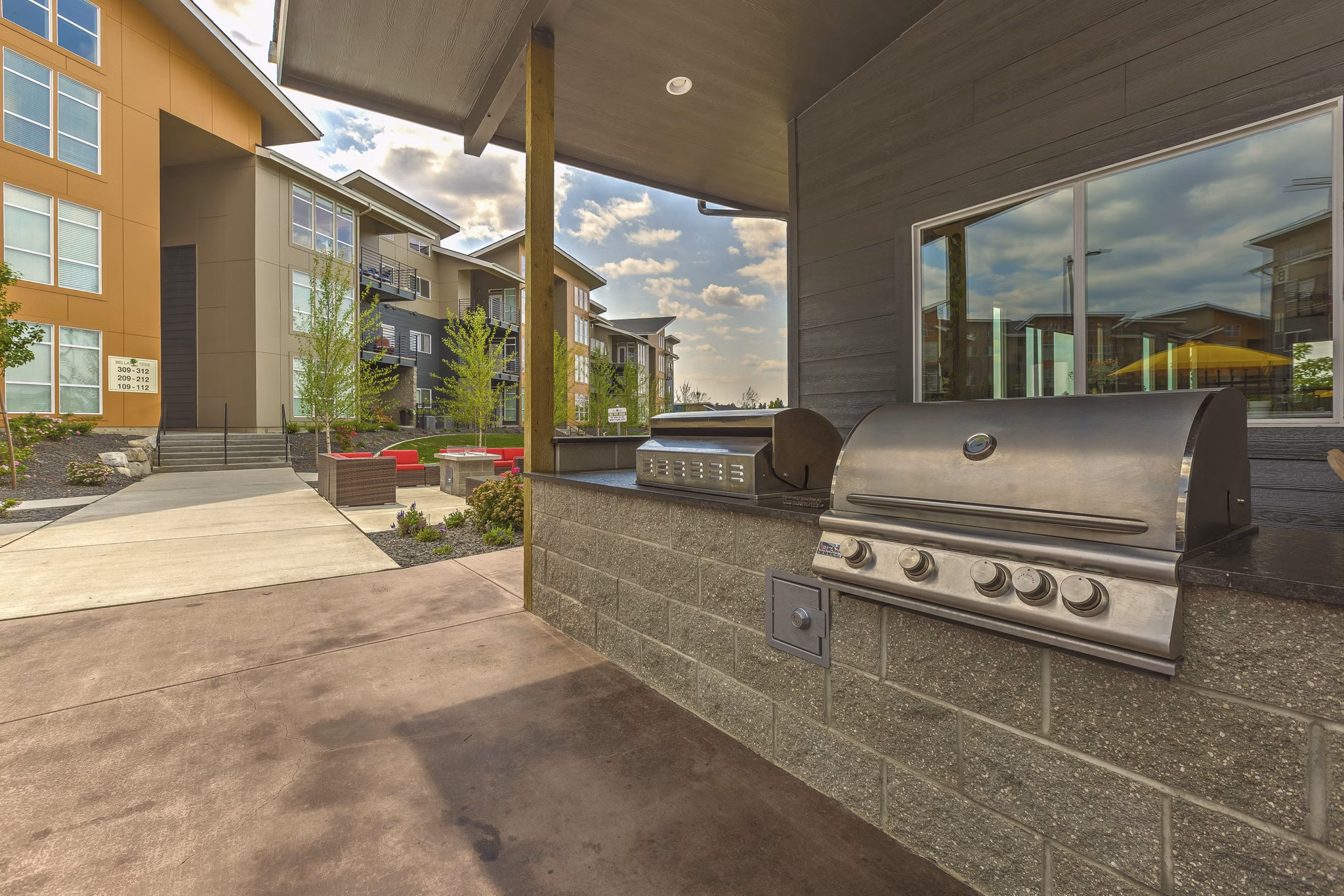 Outdoor grilling area with modern amenities at Bella Tess Apartments in Greystar community