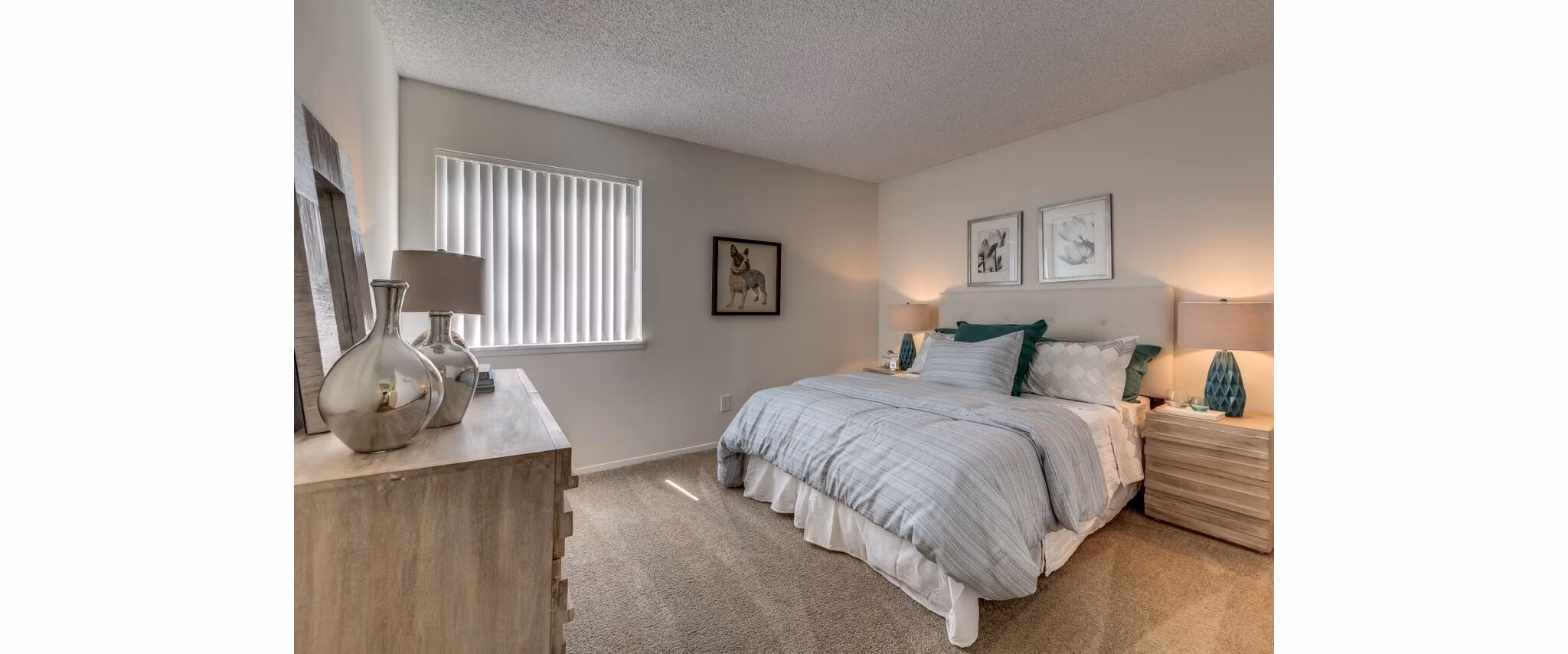 Modern bedroom with sleek decor at Onyx Apartments, featuring cozy lighting and stylish furnishings