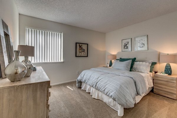 Modern bedroom with sleek decor at Onyx Apartments, featuring cozy lighting and stylish furnishings