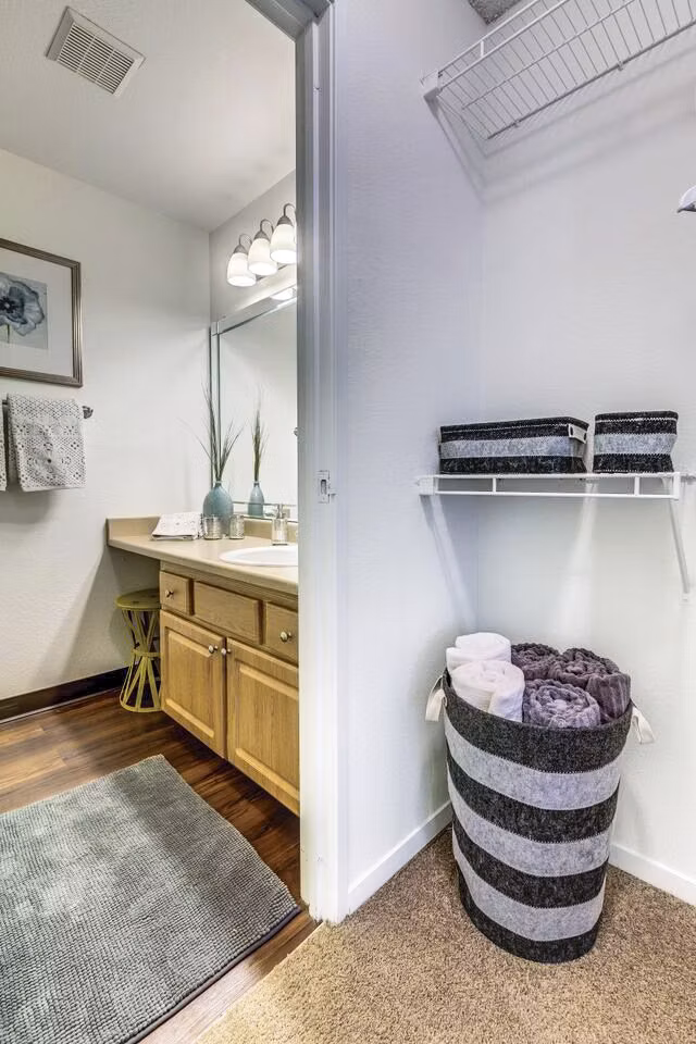 Bedroom closet with sleek shelving and ample storage space in Onyx Apartments, a luxury Greystar property