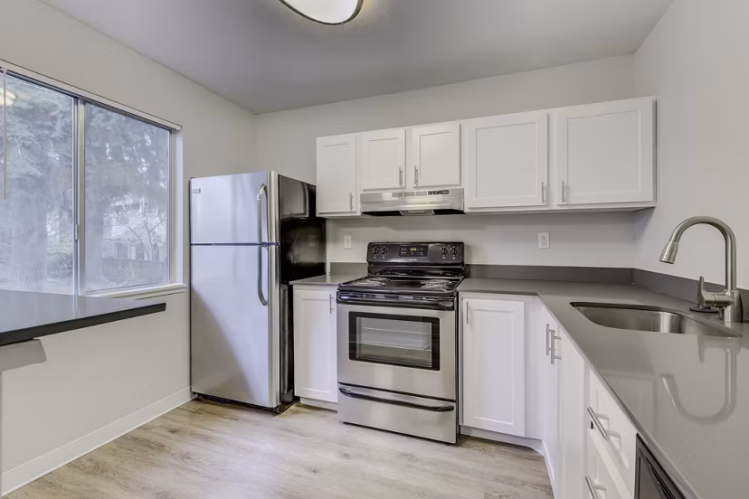 Modern kitchen with stainless steel appliances at Onyx Apartments