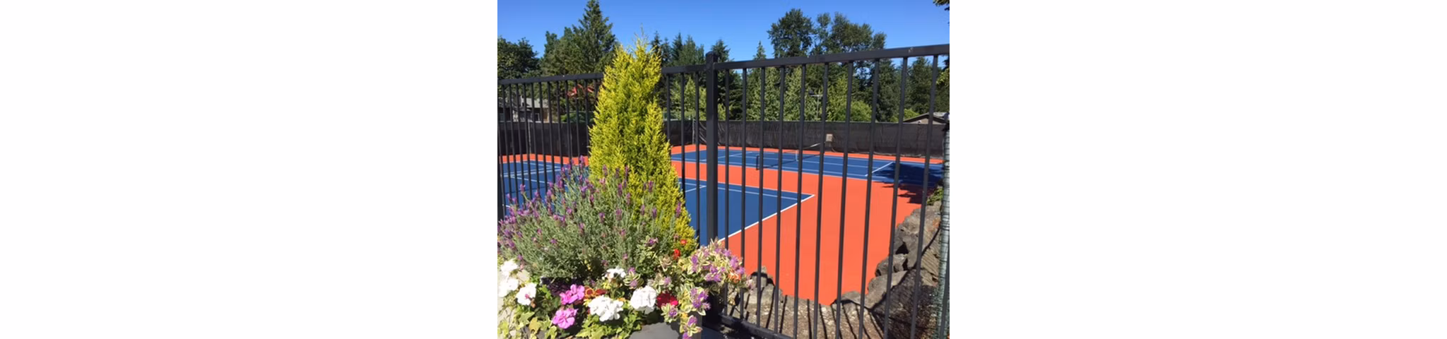 Outdoor tennis courts at Onyx Apartments featuring well-maintained surfaces and scenic views in a vibrant, residential area