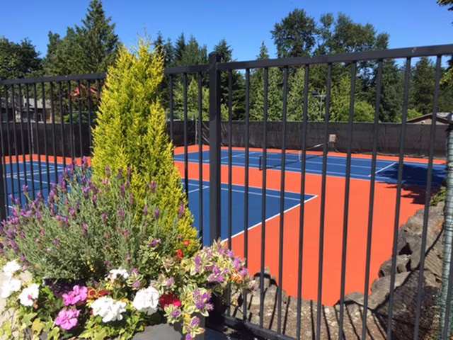 Outdoor tennis courts at Onyx Apartments featuring well-maintained surfaces and scenic views in a vibrant, residential area