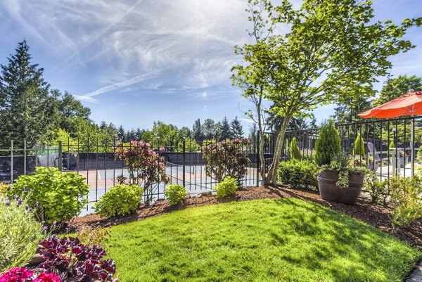 Modern tennis court at Onyx Apartments: luxury amenity offering in a vibrant community setting