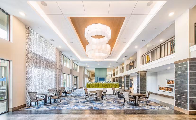 Elegant clubhouse with modern design at Overture Crabtree Apartments, perfect for gatherings and community events in a luxury living environment