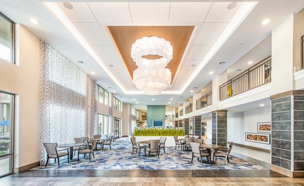 Elegant clubhouse with modern design at Overture Crabtree Apartments, perfect for gatherings and community events in a luxury living environment