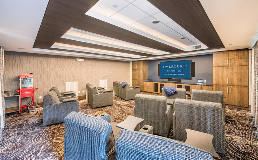 Theater with plush seating at Overture Crabtree Apartments, a luxury Greystar community in Raleigh, designed for residents' entertainment