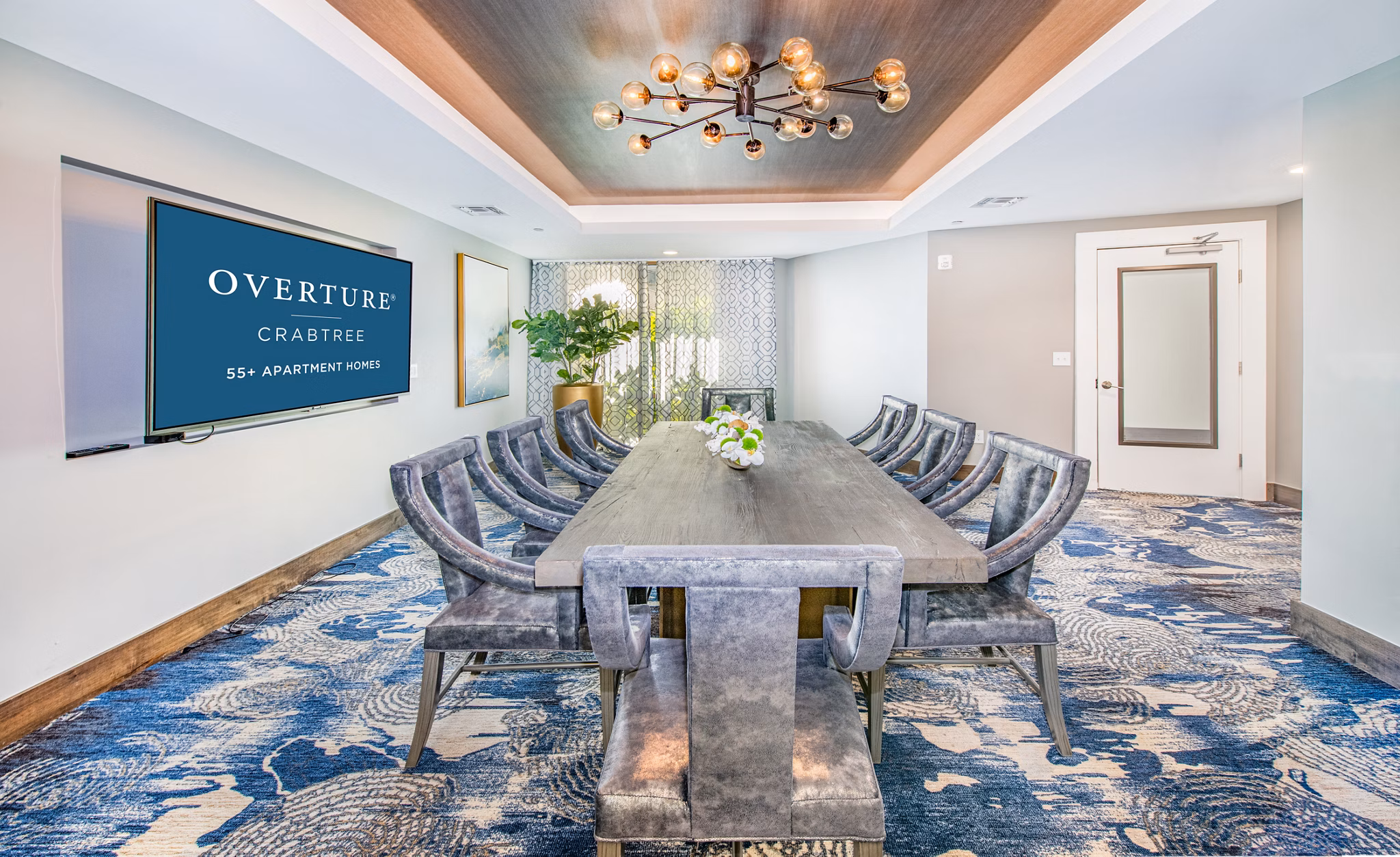 Meeting room with modern seating at Overture Crabtree, luxury apartments by Greystar in Raleigh, perfect for business gatherings and events