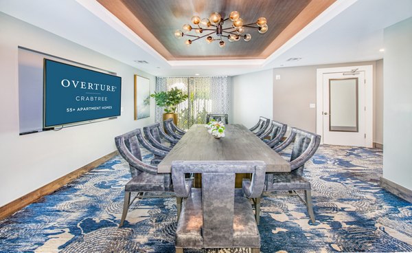 Meeting room with modern seating at Overture Crabtree, luxury apartments by Greystar in Raleigh, perfect for business gatherings and events