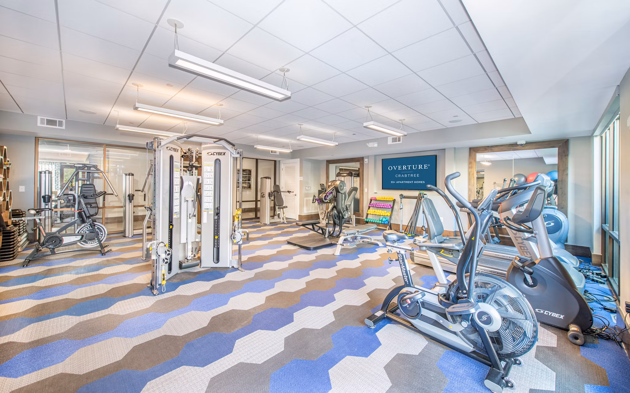 State-of-the-art fitness center with modern equipment at Overture Crabtree Apartments designed for active lifestyles and wellness