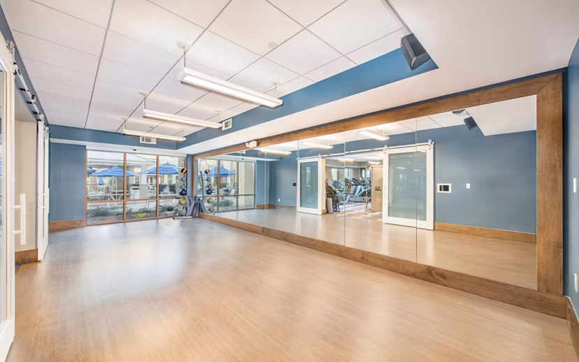 Yoga and spin studio with modern equipment at Overture Crabtree Apartments, a luxury community offering wellness amenities