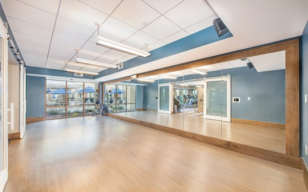 Yoga and spin studio with modern equipment at Overture Crabtree Apartments, a luxury community offering wellness amenities