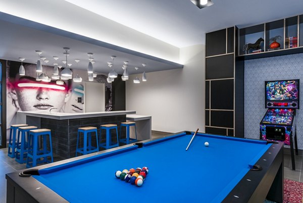 Game room featuring billiards table and modern decor at The Henri at Pike & Rose Apartments, offering luxury amenities and entertainment spaces