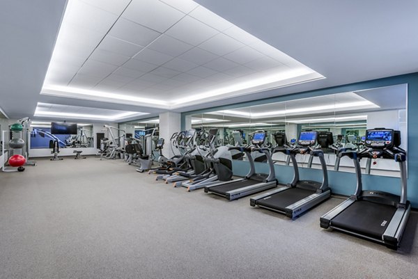 Modern gym featuring treadmills and exercise bikes at luxury apartments