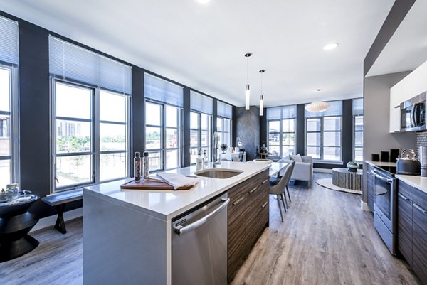 Modern kitchen with stainless steel appliances in Greystar luxury apartments