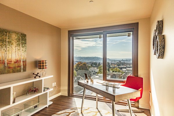 Cozy bedroom with modern furnishings at Ballard Public Lofts & Market Apartments