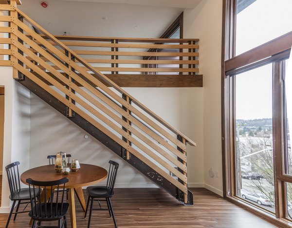 Dining room with stylish furnishings and modern lighting at Ballard Public Lofts & Market Apartments