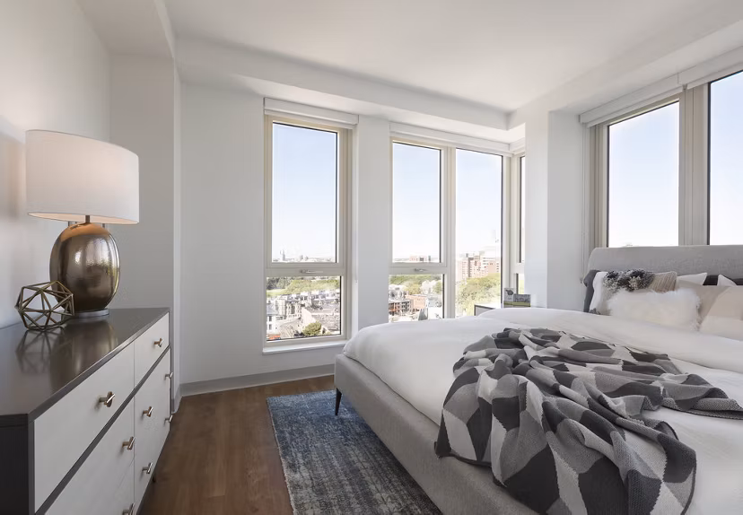 Serenity Apartments: Elegant bedroom with modern decor and plush bedding in luxury setting
