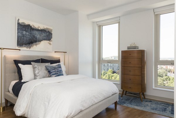 Cozy bedroom with modern decor in Serenity Apartments, featuring luxury comfort and style in every detail