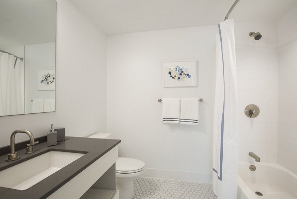 Luxurious bathroom featuring modern fixtures at Serenity Apartments, a high-end property