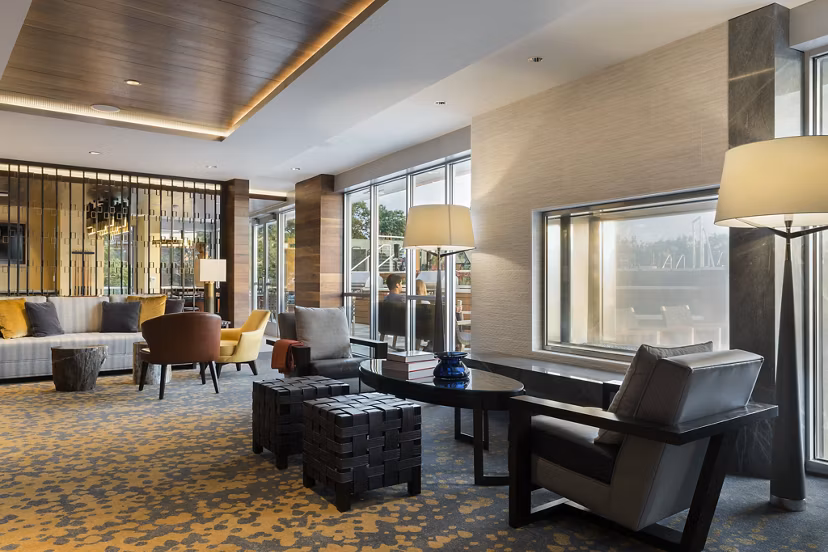 Stylish clubroom featuring modern seating and games at Serenity Apartments