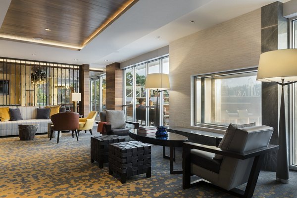 Stylish clubroom featuring modern seating and games at Serenity Apartments