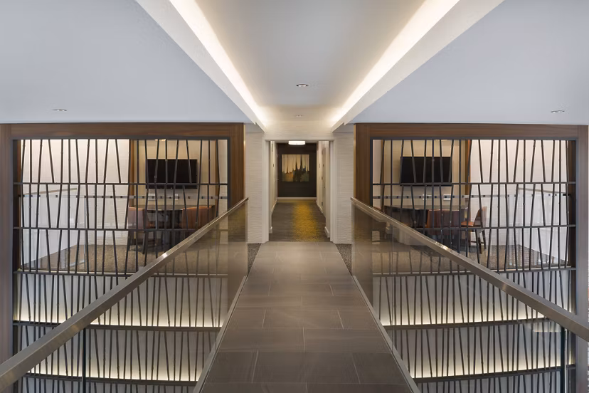Spacious hallway with modern lighting and decor at Serenity Apartments, offering luxury living in a welcoming ambiance