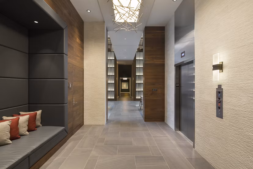 Hallway featuring modern lighting and elegant artwork at Serenity Apartments