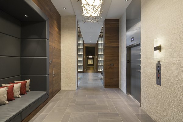Hallway featuring modern lighting and elegant artwork at Serenity Apartments