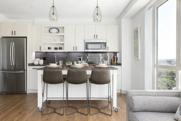 Modern kitchen with stainless steel appliances in Serenity Apartments