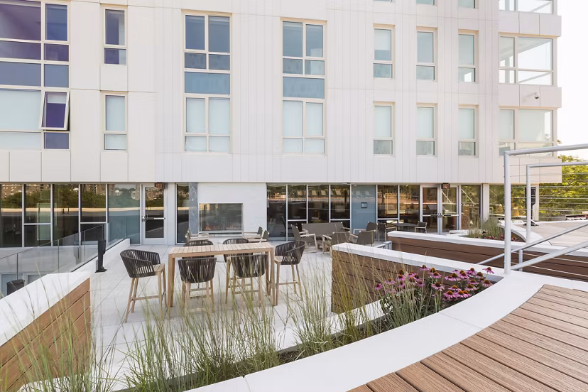 Spacious patio with modern furniture at Serenity Apartments, perfect for outdoor relaxation and gatherings