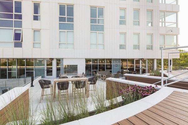 Spacious patio with modern furniture at Serenity Apartments, perfect for outdoor relaxation and gatherings